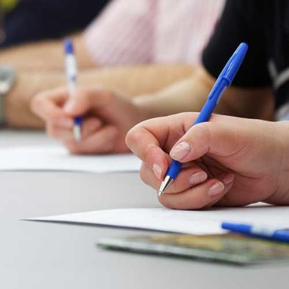 hands writing with pens