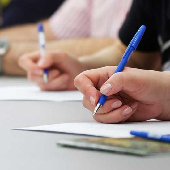 hands writing with pens